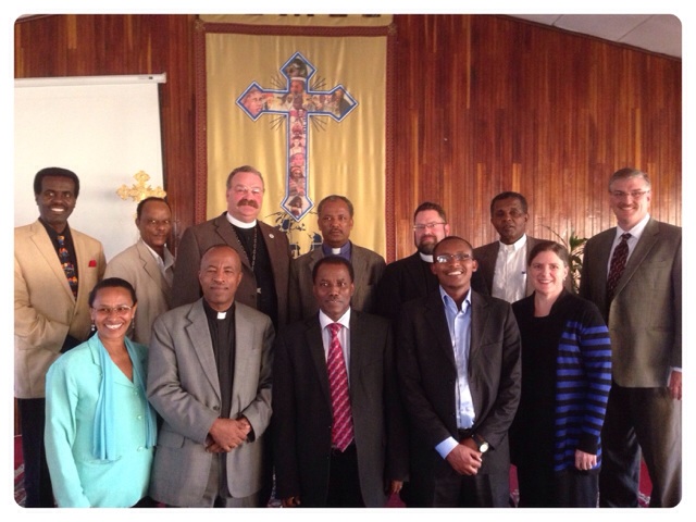 EECMY and LCMS leaders, including President Harrison (left of cross banner) and President Idosa (right of cross banner) meet in Addis Ababa, Ethiopia. 