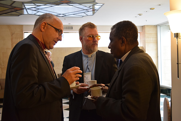 Discussion at the ILC's 2015 World Conference spill into the coffee break. Bishop Hans Jorg Voigt (ILC Chairman and head of the Independent Evangelical Lutheran Church in Germany) and Chairman Jon Ehlers (Evangelical Church of England) speak with General Secretary Ofga Berhanu (Ethiopian Evangelical Church Mekane Yesus).